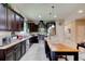 A functional kitchen with dark cabinets and a center island at 30210 Donnington Loop, Mount Dora, FL 32757