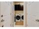 Efficient laundry room with modern washer and dryer, complemented by dark cabinets for ample storage at 30210 Donnington Loop, Mount Dora, FL 32757