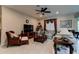 A warm living room with nice furniture, a ceiling fan, and a flat-screen TV at 30210 Donnington Loop, Mount Dora, FL 32757