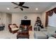 A bright living room with a ceiling fan and a flat-screen TV at 30210 Donnington Loop, Mount Dora, FL 32757
