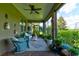 A patio surrounded by potted plants and green landscaping at 30210 Donnington Loop, Mount Dora, FL 32757