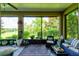 A sunroom with many potted plants and a beautiful view of the lawn at 30210 Donnington Loop, Mount Dora, FL 32757