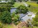 Aerial view of property next to lake, golf course, neighborhood, and lush trees at 333 Sonoma Valley Cir, Orlando, FL 32835