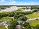Aerial view showcasing the neighborhood lake and lush greenery, complete with clear blue skies at 333 Sonoma Valley Cir, Orlando, FL 32835