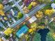 Aerial view of a tennis court near a pond with lily pads, and surrounded by residential streets and homes at 333 Sonoma Valley Cir, Orlando, FL 32835