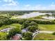 Aerial view showing the community's lake and lush greenery, complete with blue skies at 333 Sonoma Valley Cir, Orlando, FL 32835