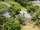 Aerial view of property surrounded by mature trees with water and neighborhoods nearby at 333 Sonoma Valley Cir, Orlando, FL 32835