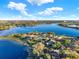 Extensive aerial of a lake surrounded by homes and trees under a blue, partially cloudy sky at 333 Sonoma Valley Cir, Orlando, FL 32835