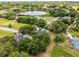 Aerial view of property near lake, golf course, roads, and neighborhood at 333 Sonoma Valley Cir, Orlando, FL 32835