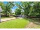 Expansive backyard with artificial grass, a wooden deck, and mature trees, ideal for outdoor gatherings at 333 Sonoma Valley Cir, Orlando, FL 32835