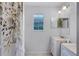 Bathroom with serene lake view window and relaxing floral-themed shower curtain at 333 Sonoma Valley Cir, Orlando, FL 32835