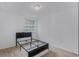 This bedroom has a modern bed frame with sleek, laminated floors and a bright window at 333 Sonoma Valley Cir, Orlando, FL 32835