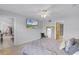 Spacious bedroom with a ceiling fan, a TV, and doorways leading to other rooms in the home at 333 Sonoma Valley Cir, Orlando, FL 32835