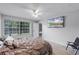Comfortable bedroom with large windows, a ceiling fan, and light wood floors at 333 Sonoma Valley Cir, Orlando, FL 32835