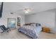 Cozy bedroom with light wood floors, a ceiling fan, and natural light from a window at 333 Sonoma Valley Cir, Orlando, FL 32835