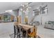Open dining room with modern chandelier, stairs to the second floor, and access to the kitchen at 333 Sonoma Valley Cir, Orlando, FL 32835