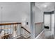 Bright hallway with wood floors and staircase, offering an inviting transition between floors at 333 Sonoma Valley Cir, Orlando, FL 32835