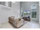 Spacious living room boasting tall ceilings, large arched windows, and comfortable seating at 333 Sonoma Valley Cir, Orlando, FL 32835