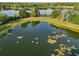 Panoramic aerial view of the lake with a charming gazebo and pier, surrounded by lush greenery and walking paths at 3446 Soho St # 108, Orlando, FL 32835