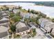 Aerial view of a vibrant community with well-maintained homes near a picturesque lake at 3446 Soho St # 108, Orlando, FL 32835
