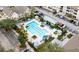 Aerial view of a community pool surrounded by lounge chairs and well-maintained landscaping at 3446 Soho St # 108, Orlando, FL 32835
