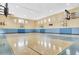 Indoor gymnasium featuring well-maintained basketball court, basketball hoops, and ample natural lighting at 3446 Soho St # 108, Orlando, FL 32835