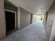 Neutral hallway showcasing entrance door to unit with smooth concrete floors and textured stucco walls at 3446 Soho St # 108, Orlando, FL 32835