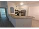 An updated kitchen with stainless steel appliances and an extended granite countertop at 3446 Soho St # 108, Orlando, FL 32835