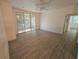 Spacious living room featuring neutral paint, modern tile flooring, and sliding glass doors to a balcony at 3446 Soho St # 108, Orlando, FL 32835