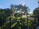 Scenic outdoor view featuring a grand oak tree, a gazebo, and a glimpse of the serene lake beyond at 3446 Soho St # 108, Orlando, FL 32835