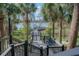 Elevated view of the pier leading to a gazebo on the lake, surrounded by lush greenery at 3446 Soho St # 108, Orlando, FL 32835