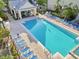 Community pool with lounge chairs and a covered pavilion with outdoor seating at 3446 Soho St # 108, Orlando, FL 32835
