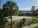 Scenic view of the lake with palm trees and tropical vegetation enhancing the outdoor ambiance at 3446 Soho St # 108, Orlando, FL 32835
