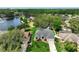 Scenic aerial view of a home near a tranquil lake surrounded by lush greenery at 3534 Woodley Park Pl, Oviedo, FL 32765