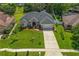 Stunning aerial view of a home showcasing its beautiful landscaping and spacious driveway at 3534 Woodley Park Pl, Oviedo, FL 32765
