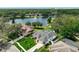 Aerial view featuring the home's landscaped yard, pool, and pond in a quiet neighborhood at 3534 Woodley Park Pl, Oviedo, FL 32765