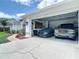 Spacious two-car garage featuring a modern car and a truck; part of a home with attractive landscaping at 3534 Woodley Park Pl, Oviedo, FL 32765