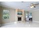 Spacious living room with tile flooring, fireplace and natural light from large windows at 3534 Woodley Park Pl, Oviedo, FL 32765