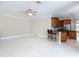 Open-concept living room showcases tile floors and a kitchen counter with barstool seating at 3534 Woodley Park Pl, Oviedo, FL 32765