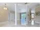 Bright and open living room with columns, neutral walls, and marble flooring that lead to the lanai at 3534 Woodley Park Pl, Oviedo, FL 32765