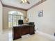 Elegant home office boasts a large window, custom trim, and plenty of space for productivity at 3534 Woodley Park Pl, Oviedo, FL 32765