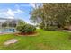 Inviting backyard with a screened-in pool, mature trees, and manicured landscaping for outdoor enjoyment at 3534 Woodley Park Pl, Oviedo, FL 32765
