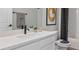 Bright bathroom features a single vanity, a large mirror and a combined tub and shower at 4409 Lions Gate Ave, Clermont, FL 34711