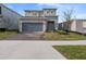 Charming two-story home featuring a stone-accented facade and a two-car garage at 4409 Lions Gate Ave, Clermont, FL 34711