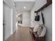 Inviting hallway with wood-look tile, coat rack, bench and decorative mirrors at 4409 Lions Gate Ave, Clermont, FL 34711