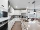 Modern kitchen with white cabinetry, stainless steel appliances, and a sleek design at 4409 Lions Gate Ave, Clermont, FL 34711