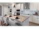 Sleek kitchen with island seating, stainless appliances, and modern finishes at 4409 Lions Gate Ave, Clermont, FL 34711