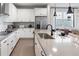 Bright kitchen with white cabinets, stainless appliances, and stylish backsplash at 4409 Lions Gate Ave, Clermont, FL 34711