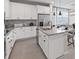 Stylish kitchen featuring white cabinetry, grey countertops and stainless steel appliances at 4409 Lions Gate Ave, Clermont, FL 34711
