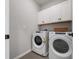 Functional laundry room with modern washer and dryer and overhead cabinets at 4409 Lions Gate Ave, Clermont, FL 34711